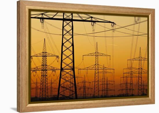 Pylons and power lines in morning light, Germany, Europe-Hans-Peter Merten-Framed Premier Image Canvas