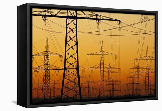 Pylons and power lines in morning light, Germany, Europe-Hans-Peter Merten-Framed Premier Image Canvas