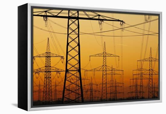 Pylons and power lines in morning light, Germany, Europe-Hans-Peter Merten-Framed Premier Image Canvas