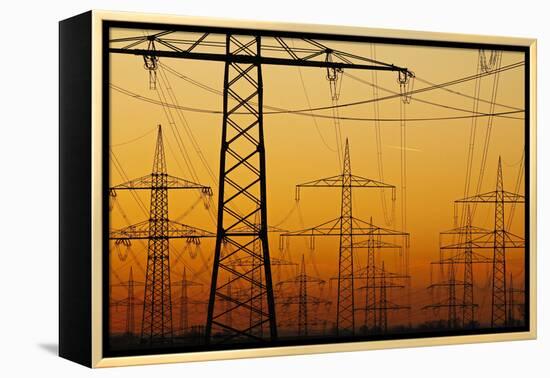 Pylons and power lines in morning light, Germany, Europe-Hans-Peter Merten-Framed Premier Image Canvas