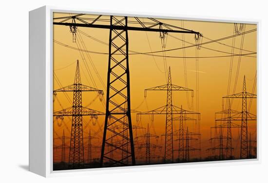 Pylons and power lines in morning light, Germany, Europe-Hans-Peter Merten-Framed Premier Image Canvas