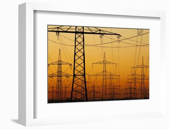 Pylons and power lines in morning light, Germany, Europe-Hans-Peter Merten-Framed Photographic Print