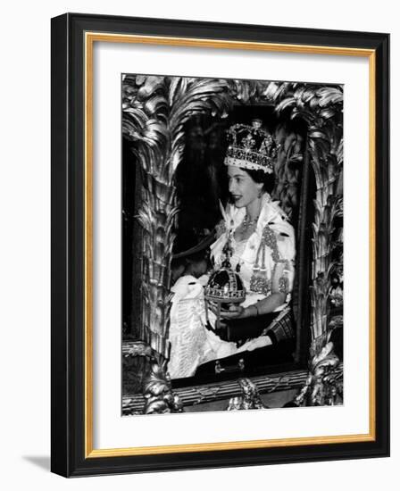 Queen Elizabeth II Riding Along in the Coronation Coach Wearing Crown and Carrying Orb-null-Framed Photographic Print