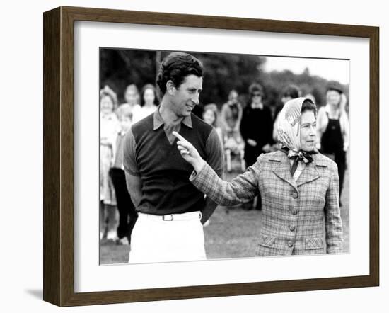 Queen Elizabeth II Shows Prince Charles Sign at a Polo Match at Windsor Great Park Points Finger-null-Framed Photographic Print