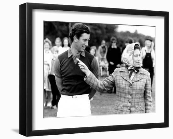 Queen Elizabeth II Shows Prince Charles Sign at a Polo Match at Windsor Great Park Points Finger-null-Framed Photographic Print