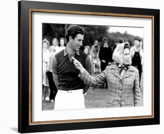 Queen Elizabeth II Shows Prince Charles Sign at a Polo Match at Windsor Great Park Points Finger-null-Framed Photographic Print