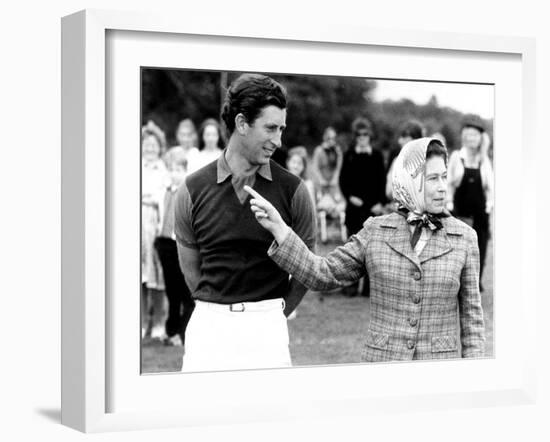 Queen Elizabeth II Shows Prince Charles Sign at a Polo Match at Windsor Great Park Points Finger-null-Framed Photographic Print