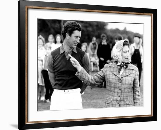 Queen Elizabeth II Shows Prince Charles Sign at a Polo Match at Windsor Great Park Points Finger-null-Framed Photographic Print