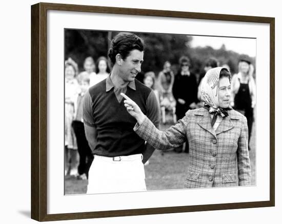 Queen Elizabeth II Shows Prince Charles Sign at a Polo Match at Windsor Great Park Points Finger-null-Framed Photographic Print