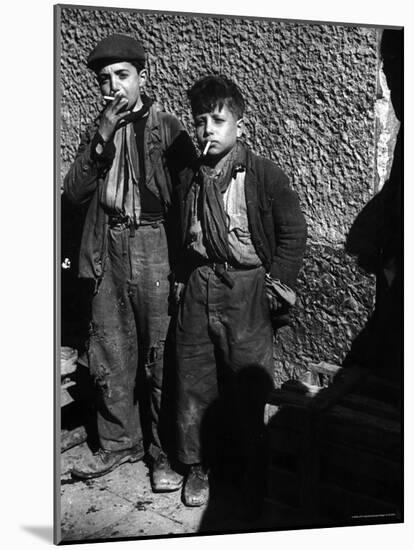 Ragged, Filthy, Poverty Stricken, Street Boys Smoking Cigarettes Begged from American Soldiers-George Rodger-Mounted Photographic Print