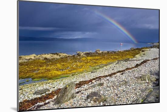 Rainbow Above Rocky Beach and Small Boat-null-Mounted Photographic Print