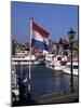 Raising the Dutch Flag by the Harbour, Volendam, Ijsselmeer, Holland-I Vanderharst-Mounted Photographic Print