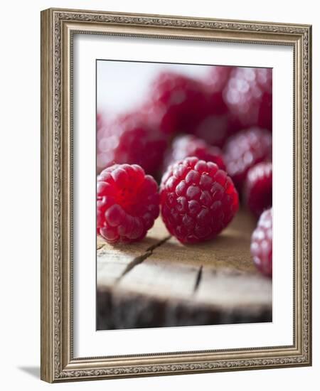 Raspberries on a Wooden Surface-Martina Schindler-Framed Photographic Print