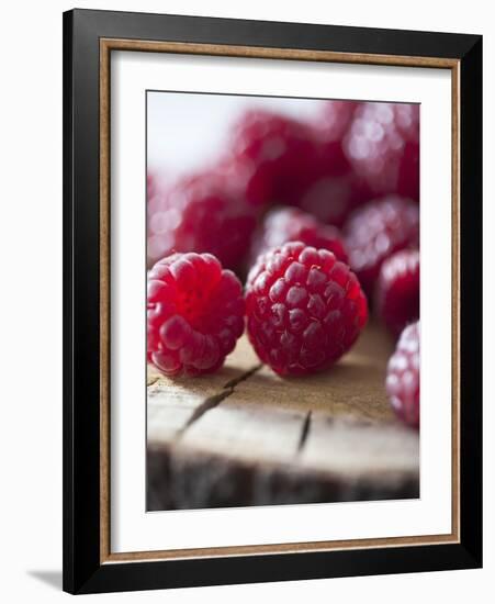 Raspberries on a Wooden Surface-Martina Schindler-Framed Photographic Print