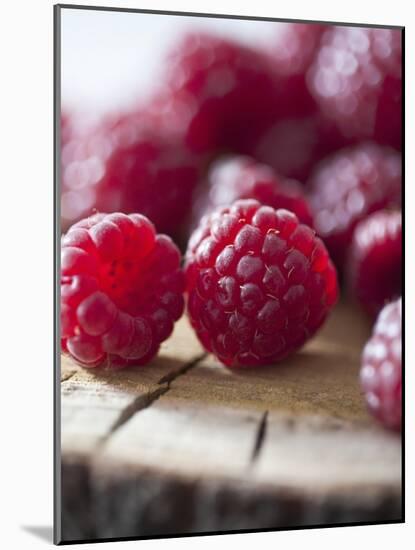 Raspberries on a Wooden Surface-Martina Schindler-Mounted Photographic Print