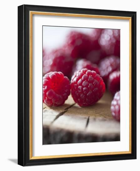 Raspberries on a Wooden Surface-Martina Schindler-Framed Photographic Print