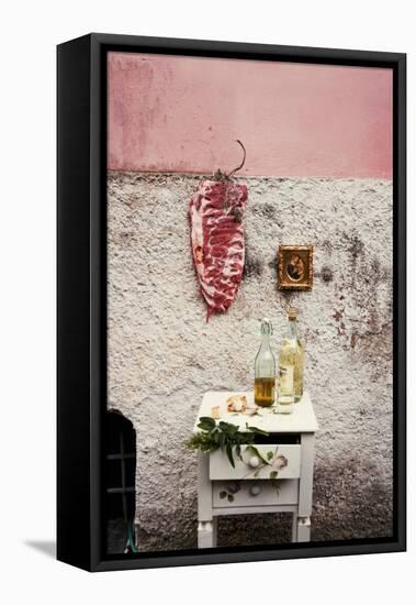 Raw Pork Ribs Hanging on the Wall of a House, Next to a A Gold-Framed Picture-Maria Brinkop-Framed Premier Image Canvas