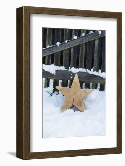 Raw Wooden Star in Front of Fence in the Snow-Andrea Haase-Framed Photographic Print