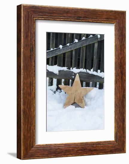 Raw Wooden Star in Front of Fence in the Snow-Andrea Haase-Framed Photographic Print