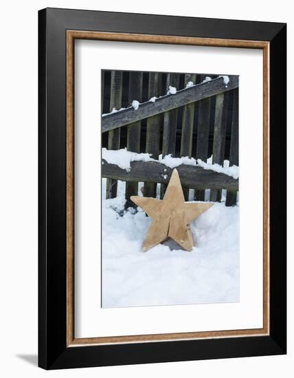 Raw Wooden Star in Front of Fence in the Snow-Andrea Haase-Framed Photographic Print