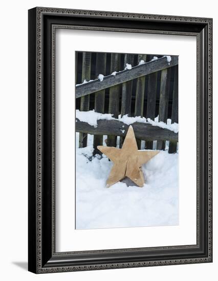 Raw Wooden Star in Front of Fence in the Snow-Andrea Haase-Framed Photographic Print