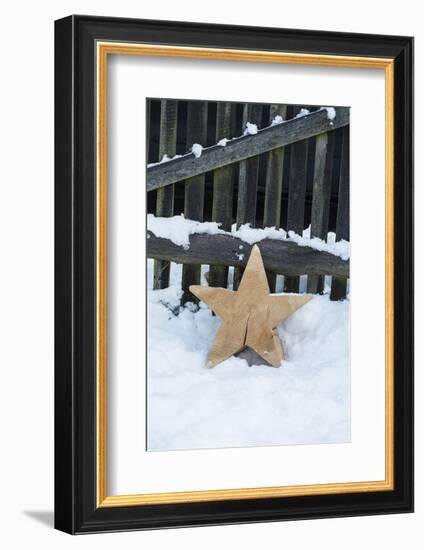 Raw Wooden Star in Front of Fence in the Snow-Andrea Haase-Framed Photographic Print