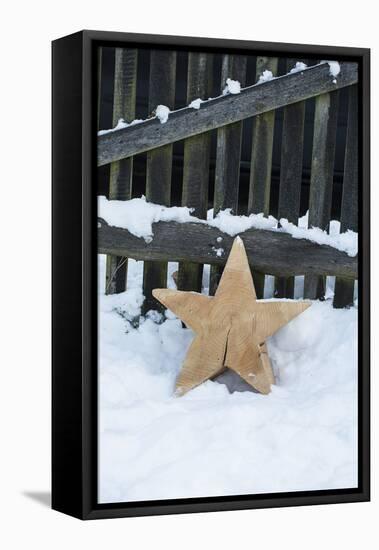 Raw Wooden Star in Front of Fence in the Snow-Andrea Haase-Framed Premier Image Canvas