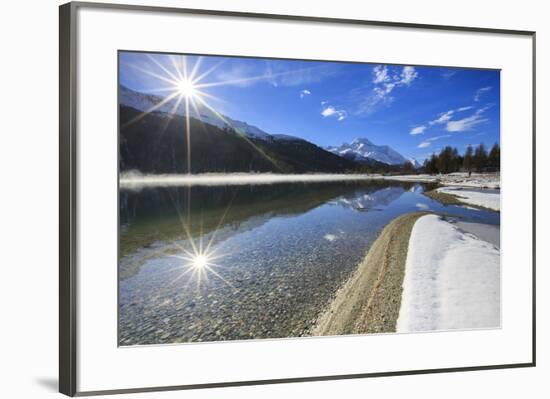 Rays of winter sun illuminate Lake Silvaplana still partially frozen Maloja Engadine Graubunden Can-ClickAlps-Framed Photographic Print