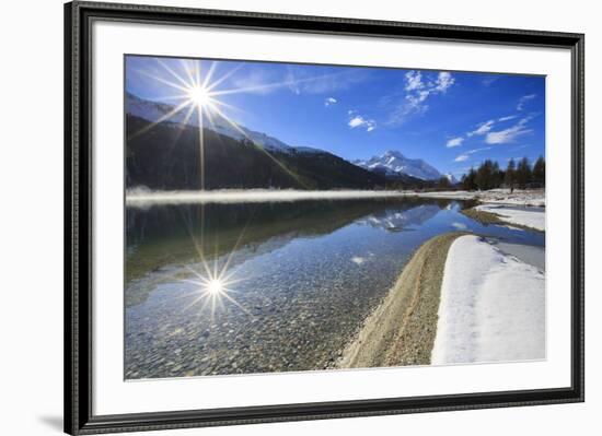 Rays of winter sun illuminate Lake Silvaplana still partially frozen Maloja Engadine Graubunden Can-ClickAlps-Framed Photographic Print
