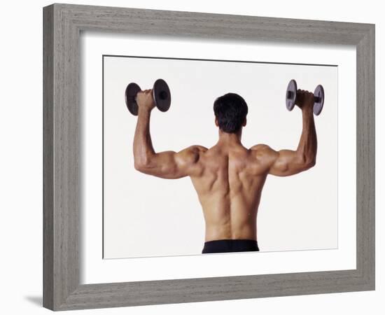 Rear View of a Man Holding Up Dumbbells-null-Framed Photographic Print