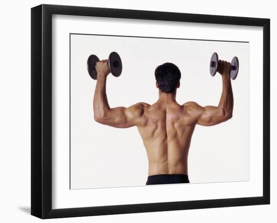 Rear View of a Man Holding Up Dumbbells-null-Framed Photographic Print