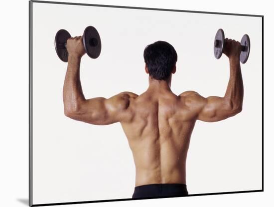 Rear View of a Man Holding Up Dumbbells-null-Mounted Photographic Print
