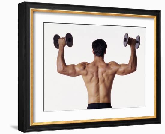 Rear View of a Man Holding Up Dumbbells-null-Framed Photographic Print