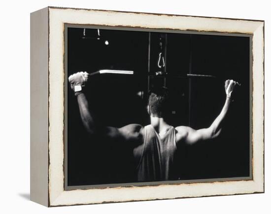 Rear View of a Young Man Exercise on a Lateral Pull-Down Weight Machine-null-Framed Premier Image Canvas