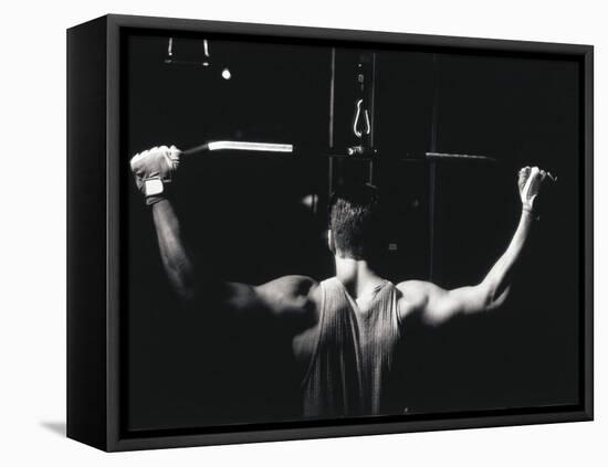 Rear View of a Young Man Exercise on a Lateral Pull-Down Weight Machine-null-Framed Premier Image Canvas