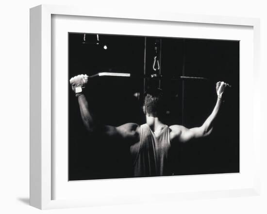 Rear View of a Young Man Exercise on a Lateral Pull-Down Weight Machine-null-Framed Photographic Print