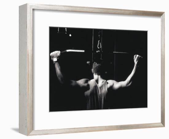 Rear View of a Young Man Exercise on a Lateral Pull-Down Weight Machine-null-Framed Photographic Print