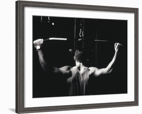 Rear View of a Young Man Exercise on a Lateral Pull-Down Weight Machine-null-Framed Photographic Print