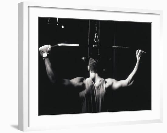 Rear View of a Young Man Exercise on a Lateral Pull-Down Weight Machine-null-Framed Photographic Print