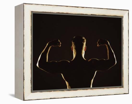 Rear View of a Young Man Flexing His Muscles-null-Framed Premier Image Canvas