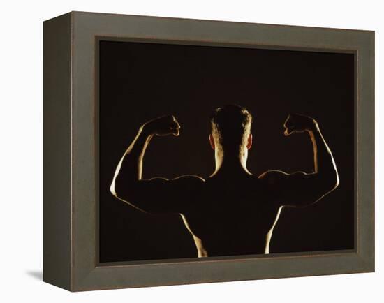 Rear View of a Young Man Flexing His Muscles-null-Framed Premier Image Canvas