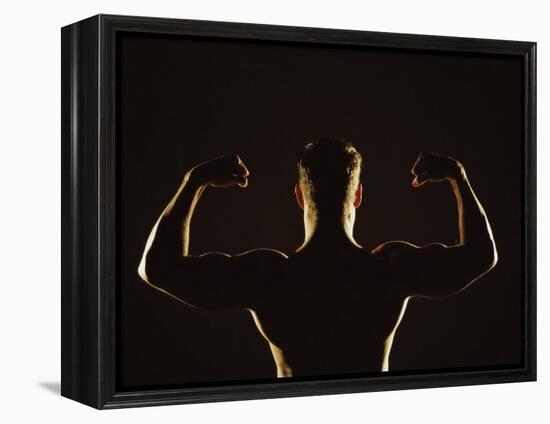 Rear View of a Young Man Flexing His Muscles-null-Framed Premier Image Canvas