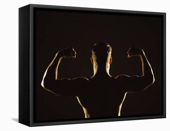 Rear View of a Young Man Flexing His Muscles-null-Framed Premier Image Canvas