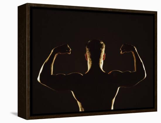 Rear View of a Young Man Flexing His Muscles-null-Framed Premier Image Canvas