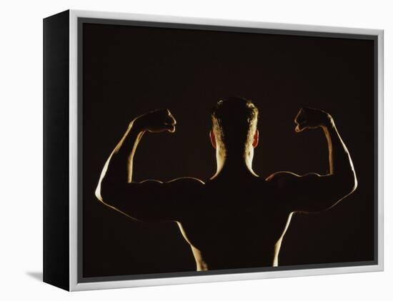 Rear View of a Young Man Flexing His Muscles-null-Framed Premier Image Canvas