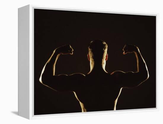 Rear View of a Young Man Flexing His Muscles-null-Framed Premier Image Canvas