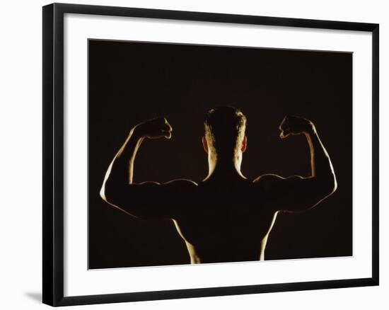 Rear View of a Young Man Flexing His Muscles--Framed Photographic Print