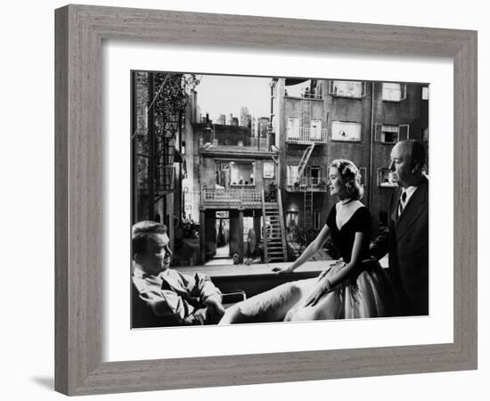 REAR WINDOW, 1954 directed byALFRED HITCHCOCK On the set, Grace Kelly between James Stewart and Alf-null-Framed Photo