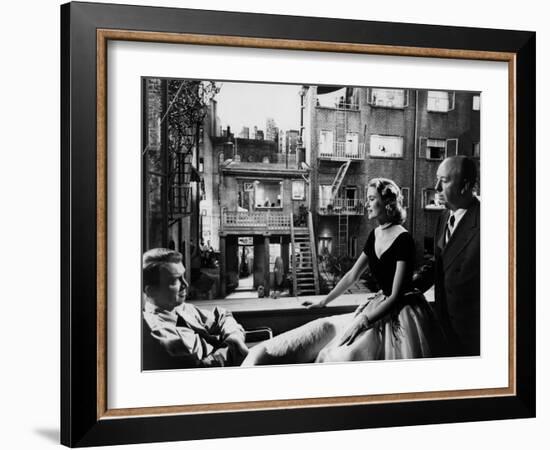 REAR WINDOW, 1954 directed byALFRED HITCHCOCK On the set, Grace Kelly between James Stewart and Alf-null-Framed Photo