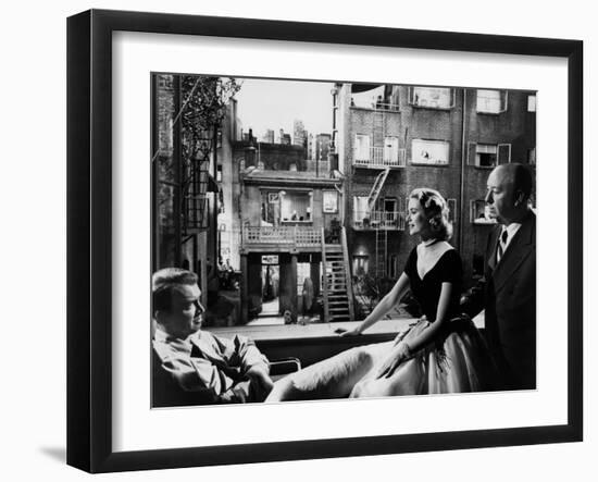 REAR WINDOW, 1954 directed byALFRED HITCHCOCK On the set, Grace Kelly between James Stewart and Alf--Framed Photo